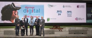 Image of partners standing in front of Science Centre sccreen with discover Digital branding