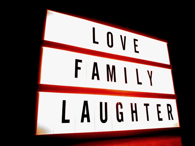 Love, family, laughter sign board