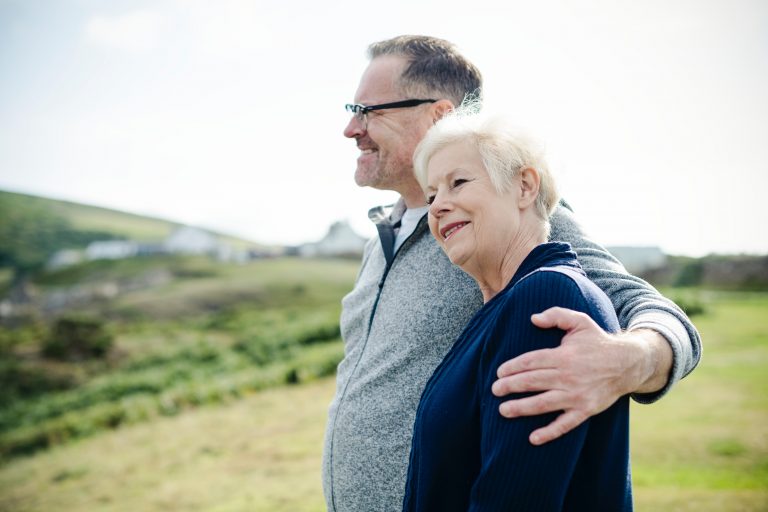 Adult couple, man has arm around woman's shoulder
