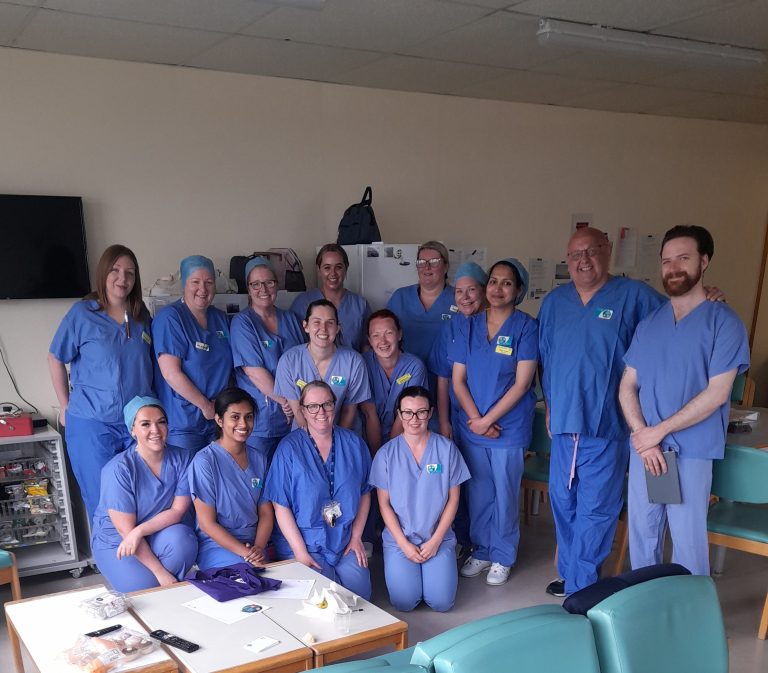 Group of Nurses with Tommy and Logan wearing scrubs